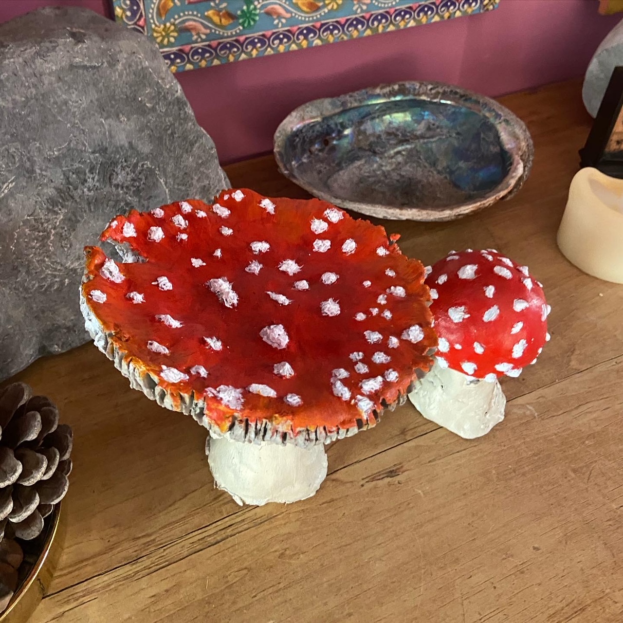 Photo of two Clay painted Fly Agaric Mushrooms